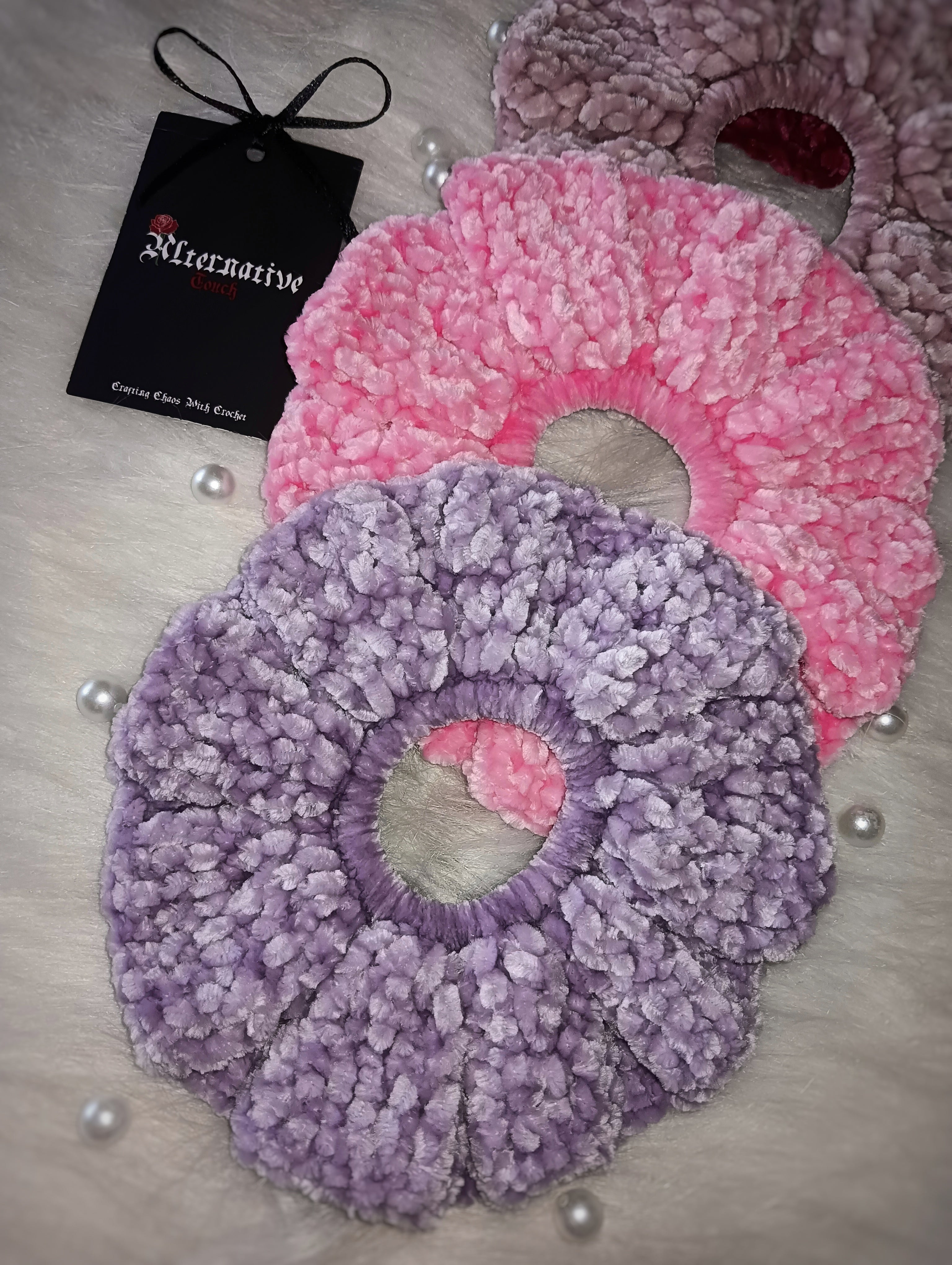 Velvet scrunchies, with a visible brand tag on a light surface.