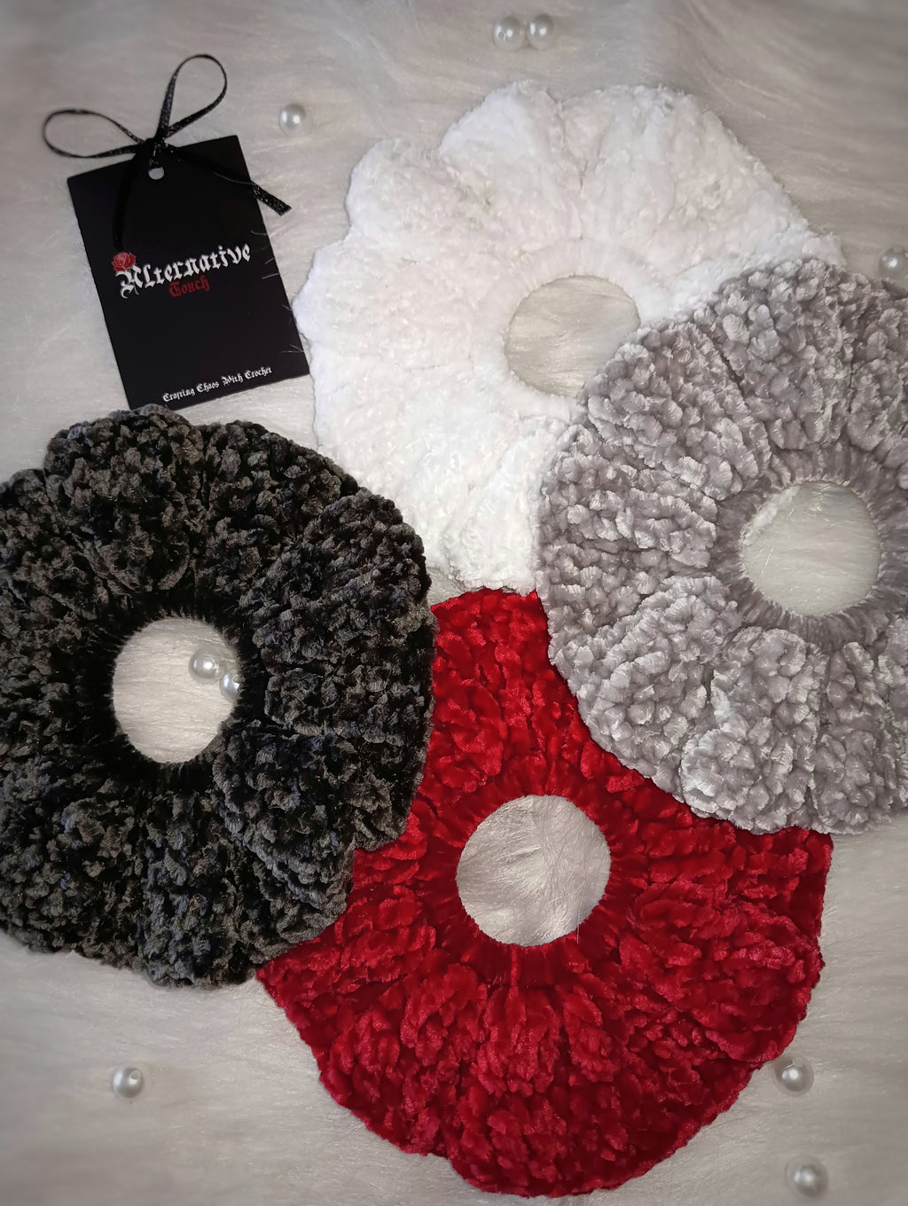Set of four velvet hair ties in white, red, light grey and dark grey with a tag labeled 'Alternative Touch' on a white background.