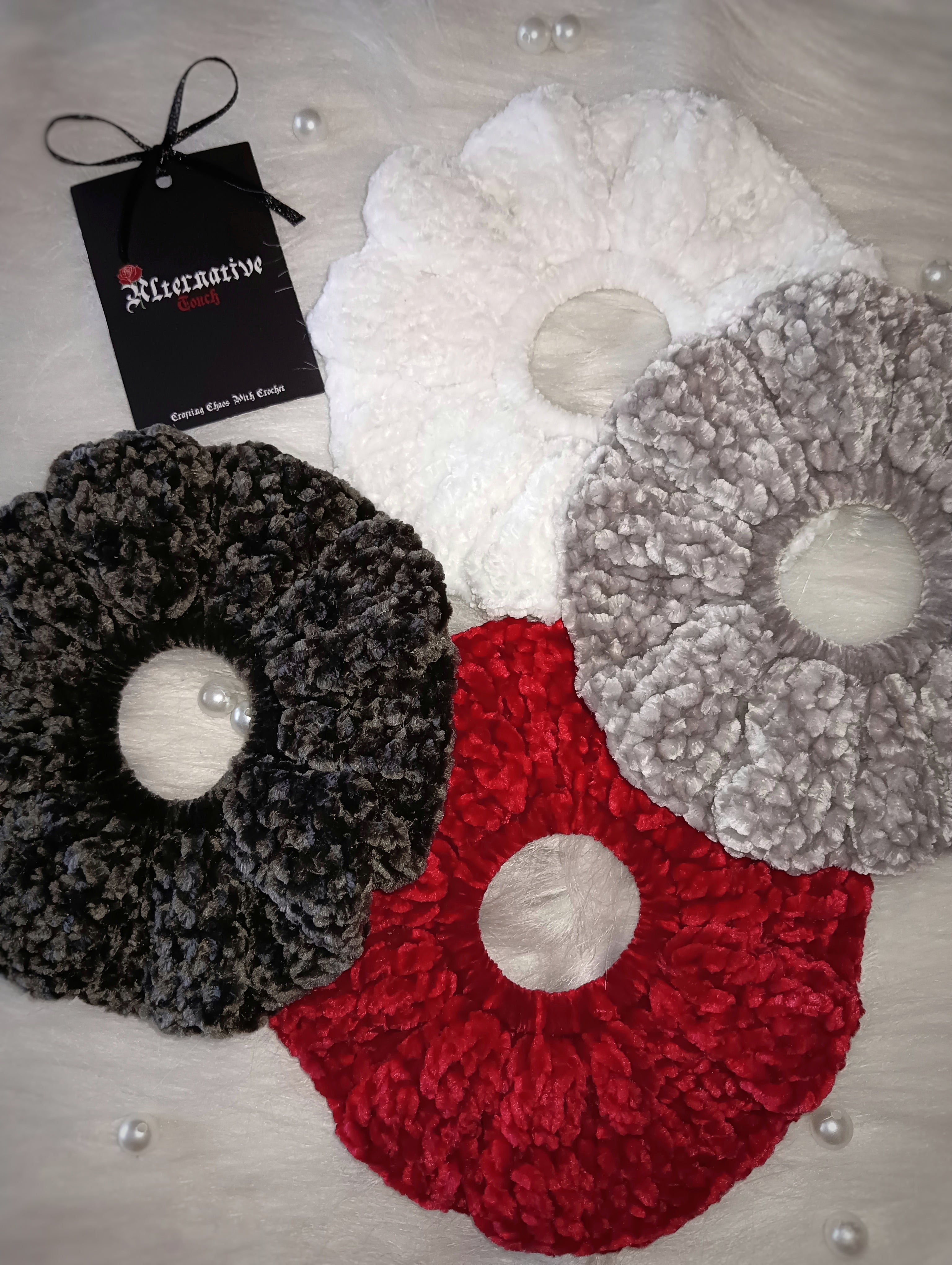 Set of four velvet hair ties in white, red, light grey and dark grey with a tag labeled 'Alternative Touch' on a white background.